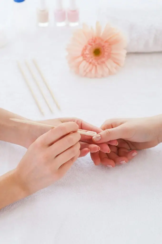 Cleaning nails. Close-up of beautician cleaning nails of female customer